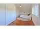 Bright bedroom with wood floors, large windows, white walls and a ceiling fan at 206 23Rd W St, Bradenton, FL 34205