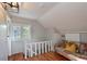 Bonus room with wood floors, bright windows, a quirky colorful couch and white walls at 206 23Rd W St, Bradenton, FL 34205