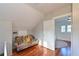 Bonus room features wood floors, bright windows, a quirky colorful couch and white walls at 206 23Rd W St, Bradenton, FL 34205