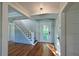 Welcoming foyer featuring a staircase, hardwood floors, beadboard walls, and natural light at 206 23Rd W St, Bradenton, FL 34205
