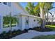 Inviting front entrance featuring a light blue door, well-maintained landscaping, and a gravel walkway at 206 23Rd W St, Bradenton, FL 34205