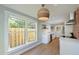 Bright kitchen featuring stainless steel appliances, white cabinets, quartz countertops, and wood flooring at 206 23Rd W St, Bradenton, FL 34205