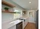Kitchen boasts floating shelves, stainless steel appliances, and granite countertops at 206 23Rd W St, Bradenton, FL 34205