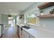 Bright open kitchen featuring white countertops and cabinetry, stainless steel appliances, and floating shelves at 206 23Rd W St, Bradenton, FL 34205