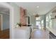 Bright open kitchen featuring wood floors, brick accent wall, stainless steel appliances, and white cabinetry at 206 23Rd W St, Bradenton, FL 34205