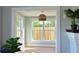 Bright sitting room with hardwood floors, large windows, and a modern hanging light fixture at 206 23Rd W St, Bradenton, FL 34205