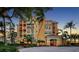 Luxurious multi-story building surrounded by lush tropical landscaping and palm trees at 2161 Gulf Of Mexico Dr # 6, Longboat Key, FL 34228