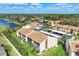 An aerial view of a condominium complex near a lake and green spaces provides a serene and appealing living environment at 2446 Clubhouse Cir # 202, Sarasota, FL 34232