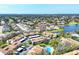Expansive aerial view showcases the community near a lake, golf course, and the city skyline in the distance at 2446 Clubhouse Cir # 202, Sarasota, FL 34232