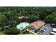 Aerial view of the community, highlighting the pool, parking, and surrounding landscape at 2446 Clubhouse Cir # 202, Sarasota, FL 34232