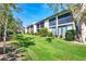 Manicured backyard featuring a lush green lawn with mature trees at 2446 Clubhouse Cir # 202, Sarasota, FL 34232