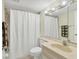 Clean bathroom featuring neutral colors, shower with curtain, and vanity at 2446 Clubhouse Cir # 202, Sarasota, FL 34232