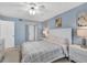 Light blue bedroom features white furniture, including nightstands, dressers, and a comfortable queen-size bed at 2446 Clubhouse Cir # 202, Sarasota, FL 34232