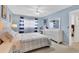 A cozy bedroom featuring soft blue walls, natural light, and a comfortable queen-sized bed invites relaxation at 2446 Clubhouse Cir # 202, Sarasota, FL 34232