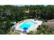 Aerial view of the community pool surrounded by lounge chairs and lush landscaping at 2446 Clubhouse Cir # 202, Sarasota, FL 34232
