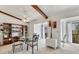 Bright dining area with vaulted ceilings, decorative wood beams, and modern furnishings creates a charming and inviting space at 2446 Clubhouse Cir # 202, Sarasota, FL 34232