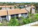 Exterior view of the condo building featuring well-kept grounds and mature trees at 2446 Clubhouse Cir # 202, Sarasota, FL 34232
