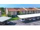 Exterior of the condo building with covered parking and well-maintained landscaping at 2446 Clubhouse Cir # 202, Sarasota, FL 34232