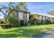 Inviting condo with lush landscaping and well-manicured lawn at 2446 Clubhouse Cir # 202, Sarasota, FL 34232