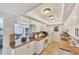 Bright kitchen with white cabinets and modern appliances creates a functional space with an opening to the living area at 2446 Clubhouse Cir # 202, Sarasota, FL 34232