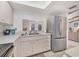 Bright kitchen features a stainless steel refrigerator and a pass-through window to another living space at 2446 Clubhouse Cir # 202, Sarasota, FL 34232
