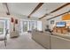 Bright living room featuring beamed ceilings, a cozy seating area, and a large sliding glass door at 2446 Clubhouse Cir # 202, Sarasota, FL 34232