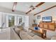 Comfortable living room with exposed beams and large windows at 2446 Clubhouse Cir # 202, Sarasota, FL 34232