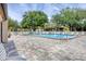 Community pool with clear water and plenty of lounge chairs, offering a relaxing spot for residents at 2446 Clubhouse Cir # 202, Sarasota, FL 34232