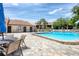 Community pool with chairs and tables, offering a relaxing spot for residents at 2446 Clubhouse Cir # 202, Sarasota, FL 34232