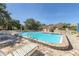 Community pool with plenty of lounge chairs, offering a relaxing spot for residents and a seven foot depth at 2446 Clubhouse Cir # 202, Sarasota, FL 34232