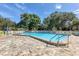 Community pool with clear water surrounded by lounge chairs, and shade trees, offering a relaxing spot for residents at 2446 Clubhouse Cir # 202, Sarasota, FL 34232