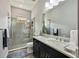 Modern bathroom featuring a walk-in glass shower, sleek vanity, and contemporary fixtures at 26800 Pavin Dr, Englewood, FL 34223