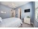 Bedroom with fan and a view of two doors and a window at 26800 Pavin Dr, Englewood, FL 34223
