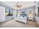 Serene bedroom with blue accents, a leaf-design ceiling fan, and white curtains creating a peaceful retreat at 26800 Pavin Dr, Englewood, FL 34223