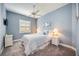 Cozy bedroom features a full size bed, blue bedding, nautical décor and a window with shutters at 26800 Pavin Dr, Englewood, FL 34223