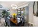 Well-appointed dining room with a view of the outdoor pool area and elegant decor at 26800 Pavin Dr, Englewood, FL 34223