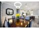 Formal dining room with elegant lighting and view into the gourmet kitchen at 26800 Pavin Dr, Englewood, FL 34223