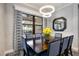 Elegant dining room with decorative lighting fixture and a view of the outdoor pool area at 26800 Pavin Dr, Englewood, FL 34223