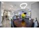 Open concept dining room, with view of kitchen, living room, and modern circular chandelier at 26800 Pavin Dr, Englewood, FL 34223