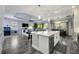 Open concept kitchen with island, stainless steel appliances, and views of the living room at 26800 Pavin Dr, Englewood, FL 34223