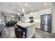Modern kitchen featuring stainless steel appliances, a center island with seating, and white cabinetry at 26800 Pavin Dr, Englewood, FL 34223
