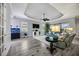 Bright living room featuring wood floors, tray ceilings, and access to outdoor pool area at 26800 Pavin Dr, Englewood, FL 34223