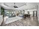 Open-concept living room featuring modern decor, wood floors, and a view of the pool area at 26800 Pavin Dr, Englewood, FL 34223