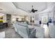 Spacious living room with open access to kitchen and dining areas, featuring wood-look flooring at 26800 Pavin Dr, Englewood, FL 34223