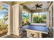 Covered outdoor space featuring a ping pong table with view to pool and landscaping at 26800 Pavin Dr, Englewood, FL 34223