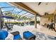 The screened lanai has comfortable seating and lounge chairs surrounding a sparkling blue pool at 26800 Pavin Dr, Englewood, FL 34223
