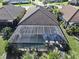 Aerial view of a screened-in pool with two blue umbrellas at 26800 Pavin Dr, Englewood, FL 34223
