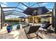 Stunning view of pool and patio area with lounge chairs, umbrellas, and outdoor seating at 26800 Pavin Dr, Englewood, FL 34223