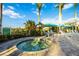 Inviting community hot tub area with lounge chairs, umbrellas and tropical landscaping in the background at 26800 Pavin Dr, Englewood, FL 34223