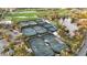 Well-maintained tennis courts surrounded by palm trees, pond and golf course at 26800 Pavin Dr, Englewood, FL 34223
